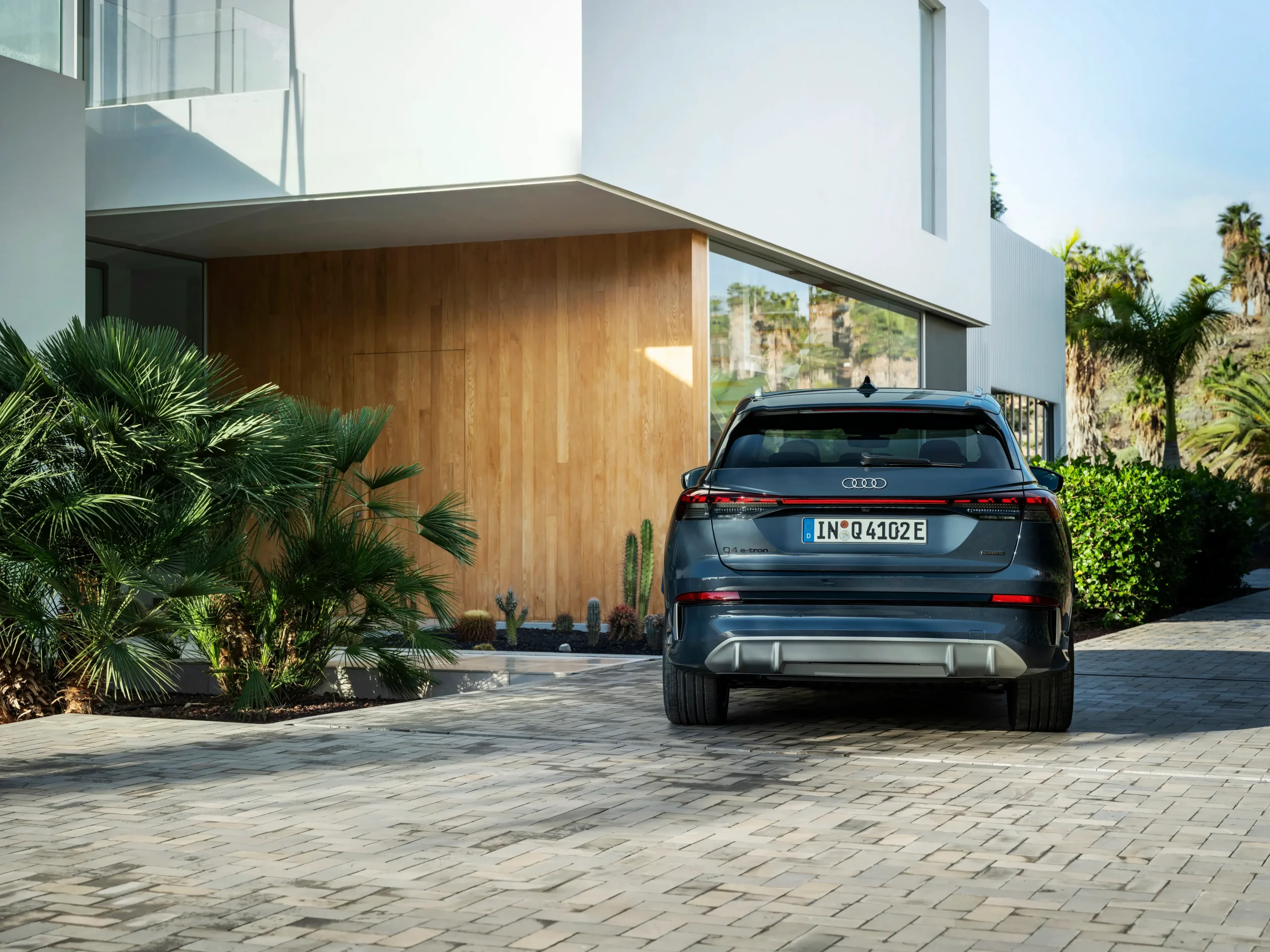 Novo Audi Q4 e-tron visto de traseira estacionado em frente a casa