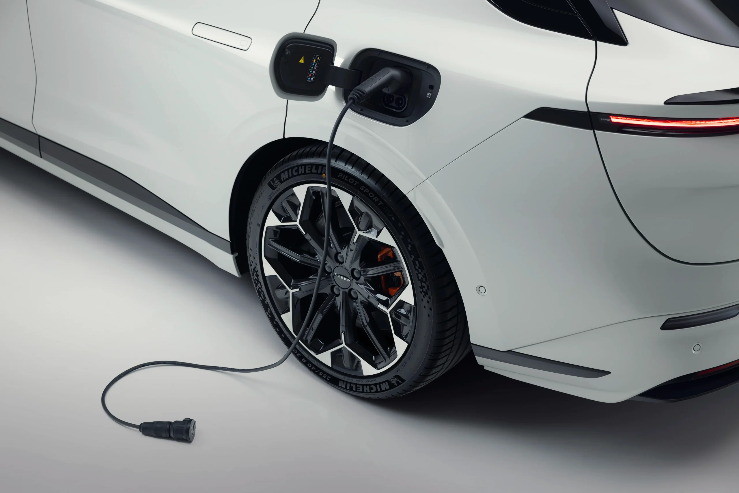 Zeekr 7GT com carregador ligado ao carro solto no chão